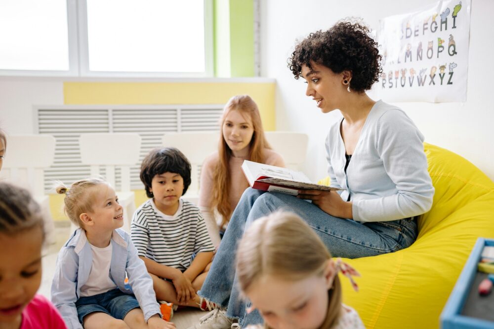 Teacher reading a book to her students