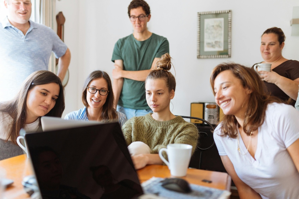 Group gathering around computer screen